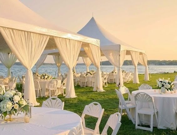 Elegant high-peak event tent setup with tables and chairs for an outdoor party rental in Murrells Inlet SC.