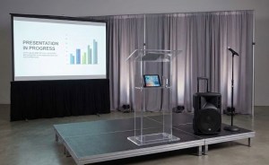 Clear acrylic podium and portable PA sound system rental setup for an outdoor event in Myrtle Beach